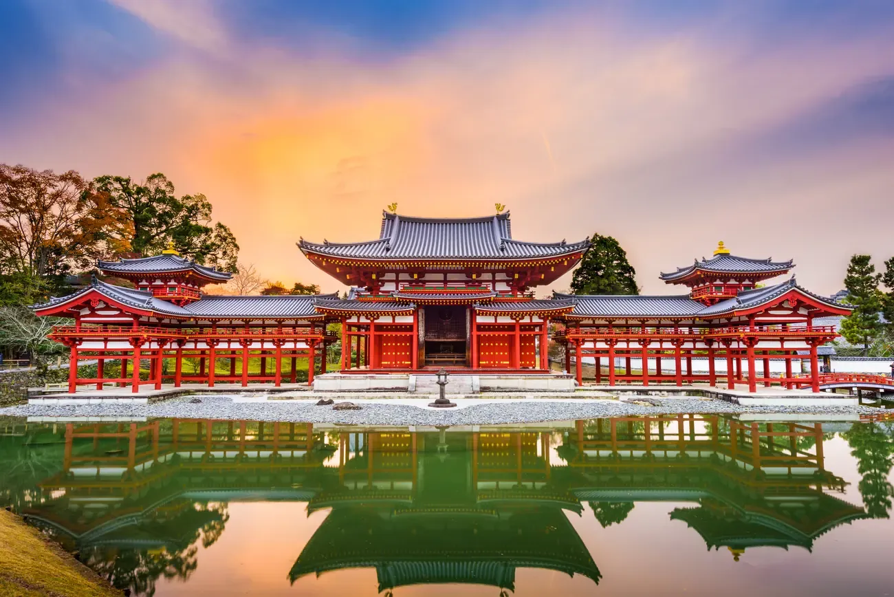 The Phoenix Hall of Byodo-in temple reflected in its pond at dusk in Uji, near Kyoto