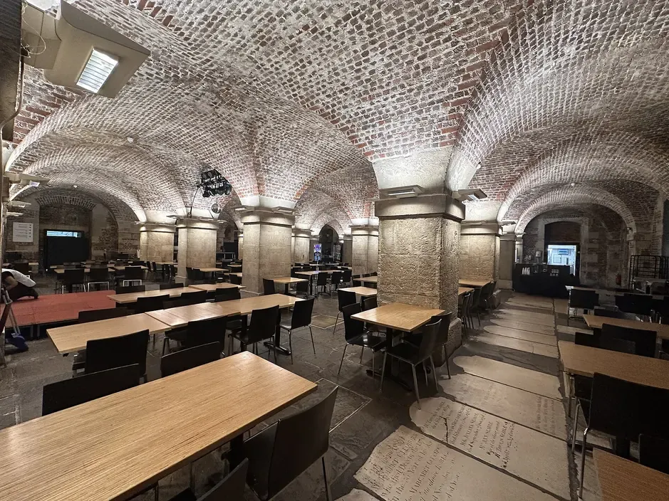Brick vaulted ceiling and tables of the Cafe in the Crypt below St Martin-in-the-Fields in London