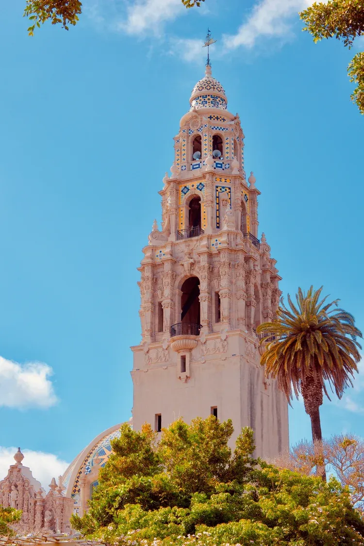 The tiled California Tower rising above the greenery of Balboa Park in San Diego