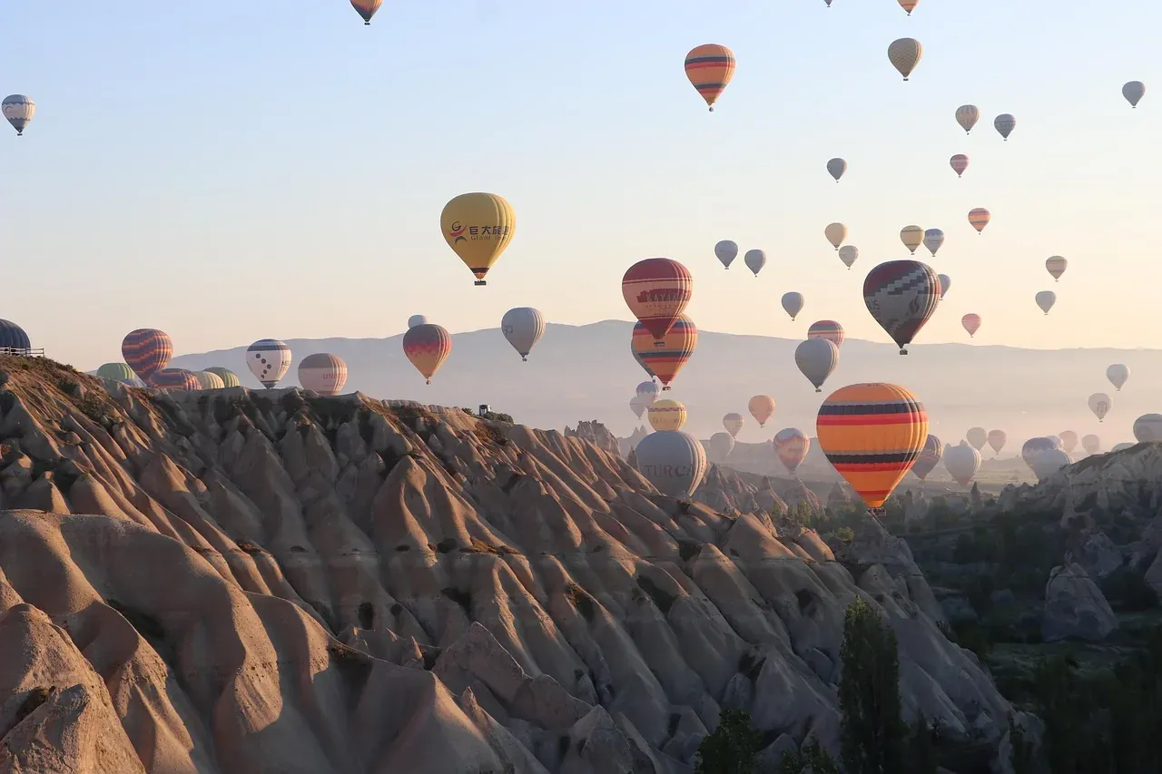 A fleet of balloons above the eroded ridges of Cappadocia