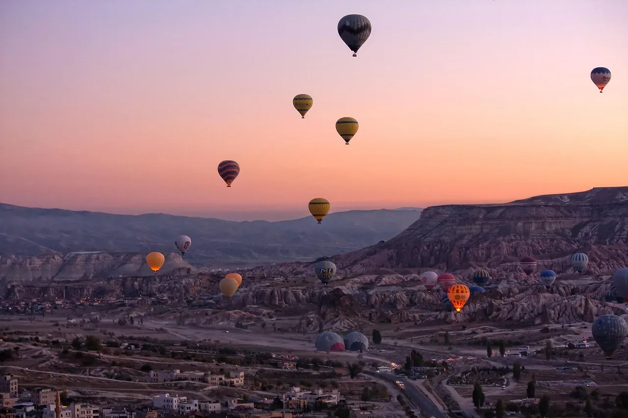 Balloons at sunrise over a valley of fairy chimneys in Cappadocia