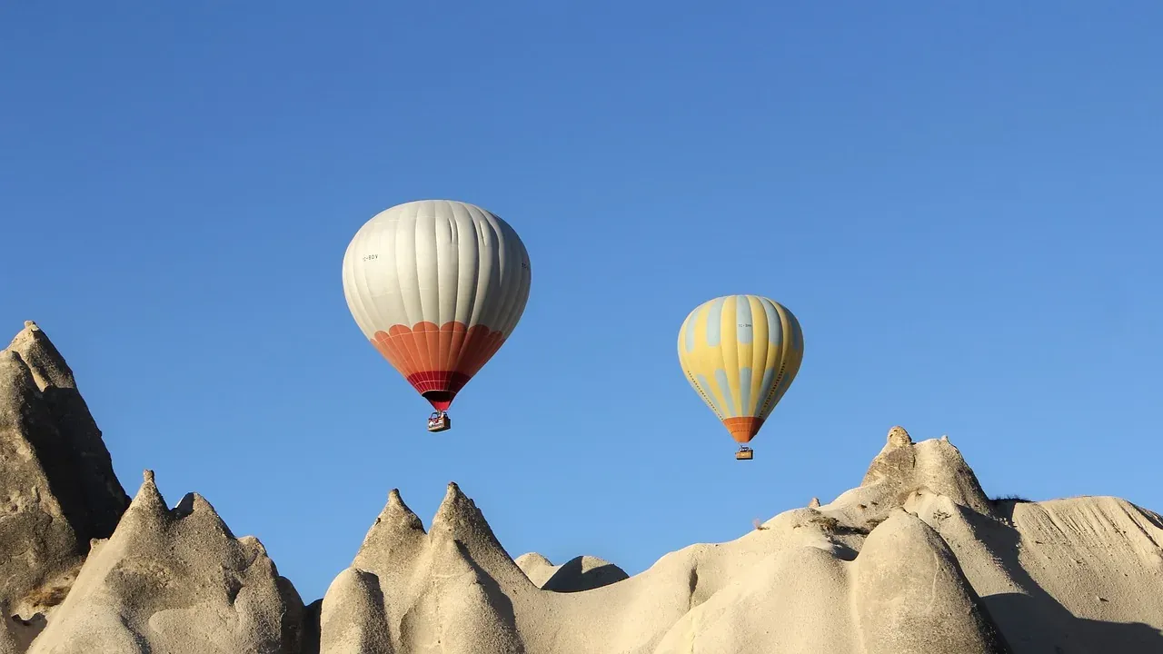 Hot air balloons rising over the fairy chimneys of Cappadocia