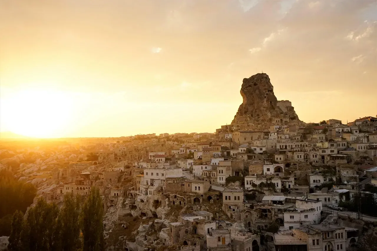 The village and castle rock of Uchisar in Cappadocia at sunset