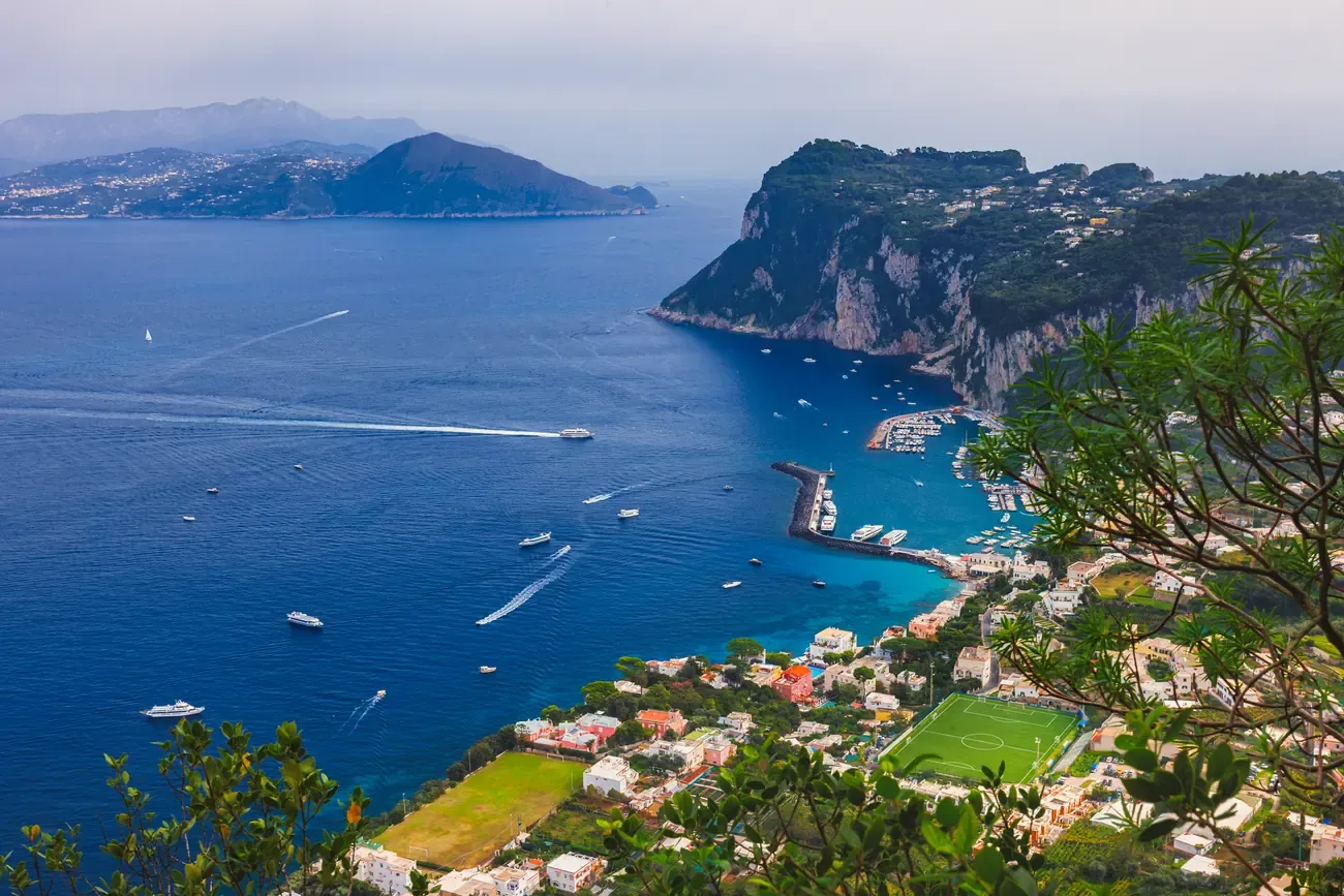 Aerial view of Capri's rugged coastline and the town spread along the clifftop