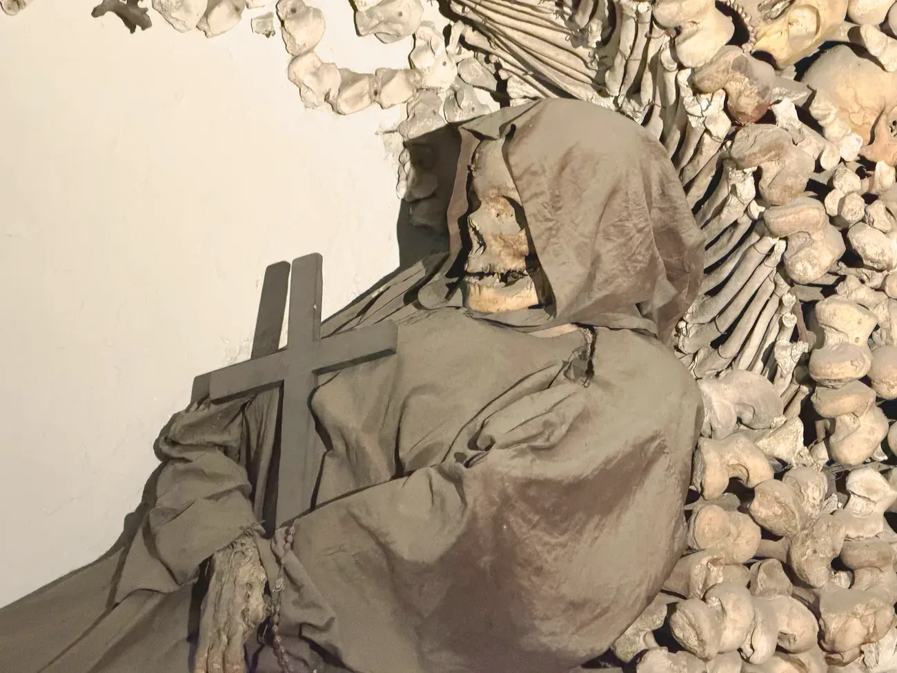 A robed friar's remains among bone decorations in the Capuchin Crypt in Rome