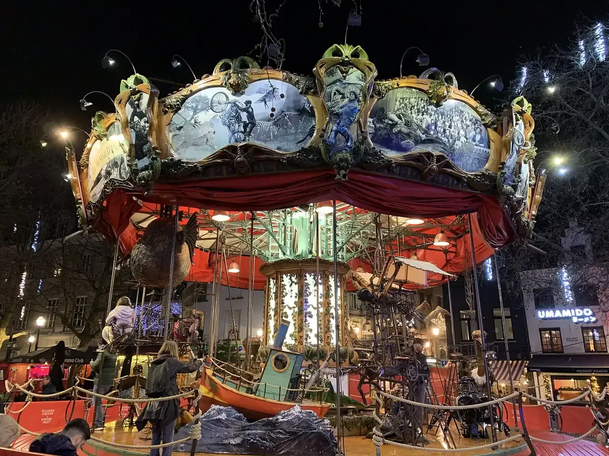 A lit hand-crafted carousel at the Winter Wonders Christmas market in Brussels at night