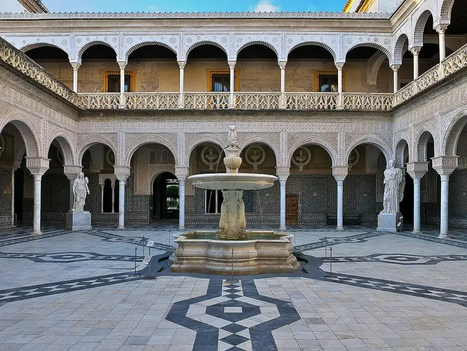 The main courtyard with its central fountain and Mudejar arcades at the Casa de Pilatos in Seville