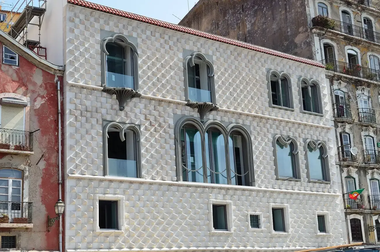 The diamond-pointed stone facade of Casa dos Bicos rising above the surrounding buildings in Lisbon