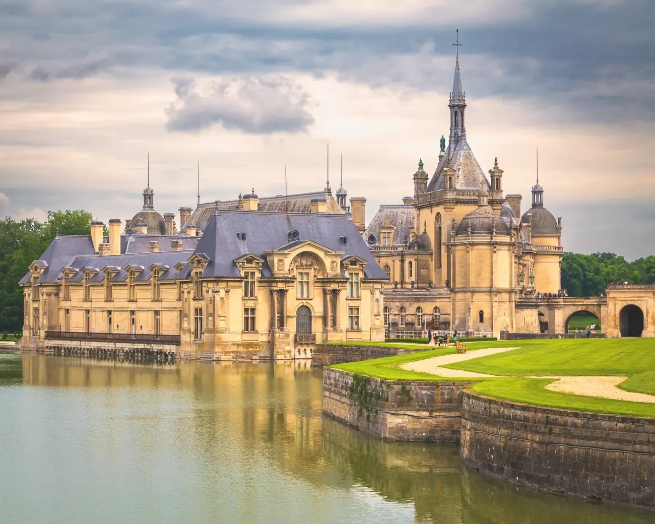 Chateau de Chantilly reflected in its moat at dusk, Oise, France