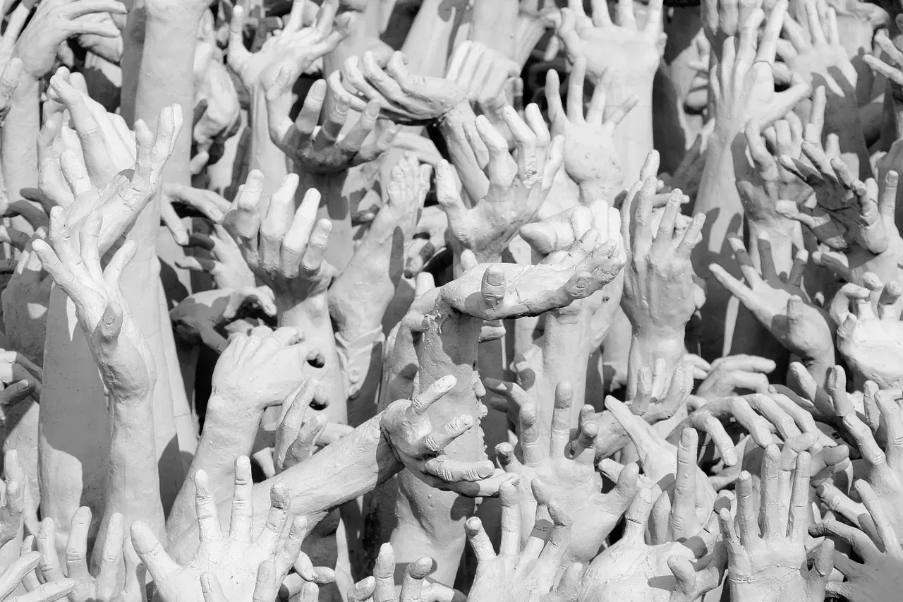 The sculpted reaching hands at the bridge of Wat Rong Khun, Chiang Rai