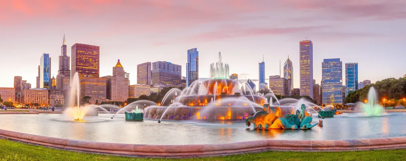Panorama of the Chicago skyline with Buckingham Fountain at sunset