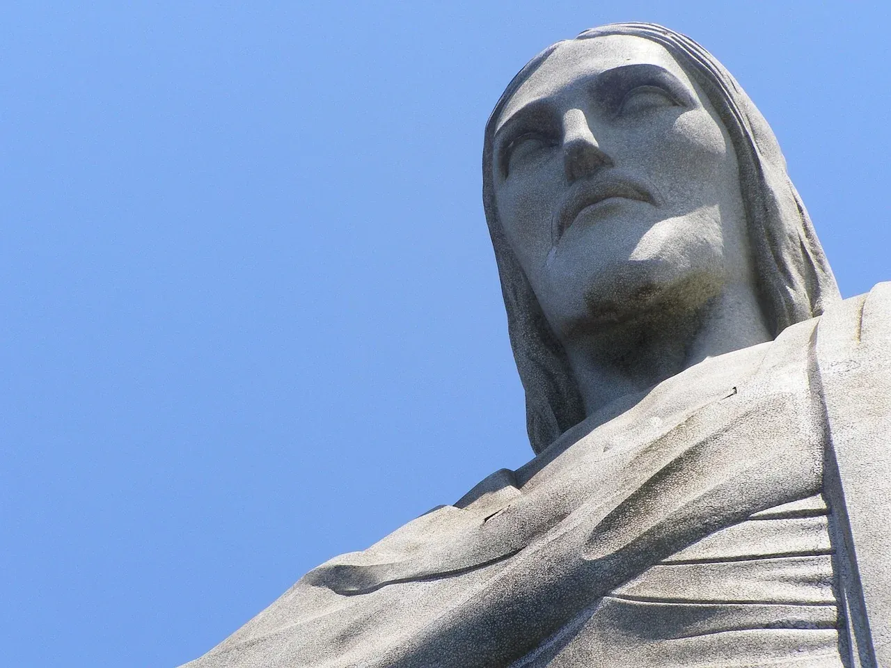 The head and outstretched arm of Christ the Redeemer seen from below on Corcovado