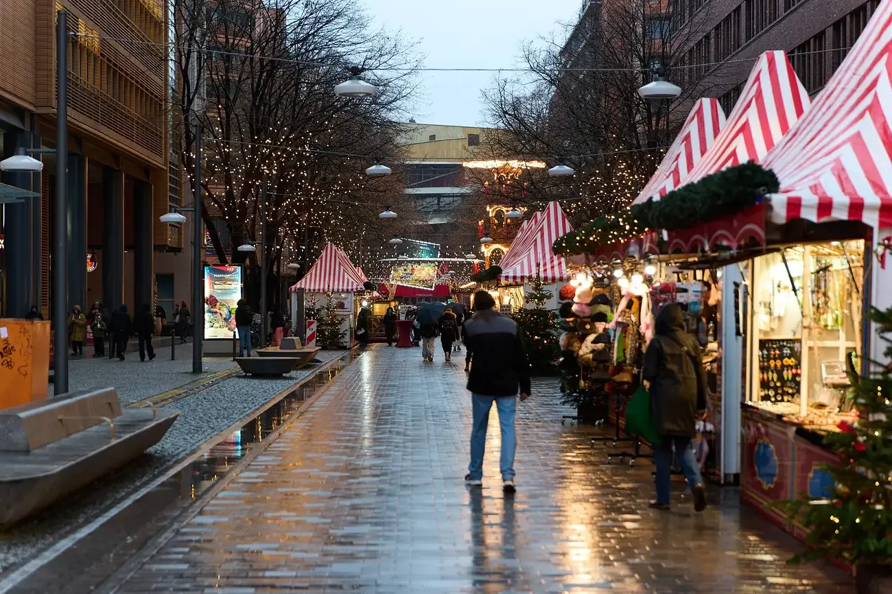 Red-and-white striped stalls along Alte Potsdamer Straße at the Christmas market at Potsdamer Platz, Berlin