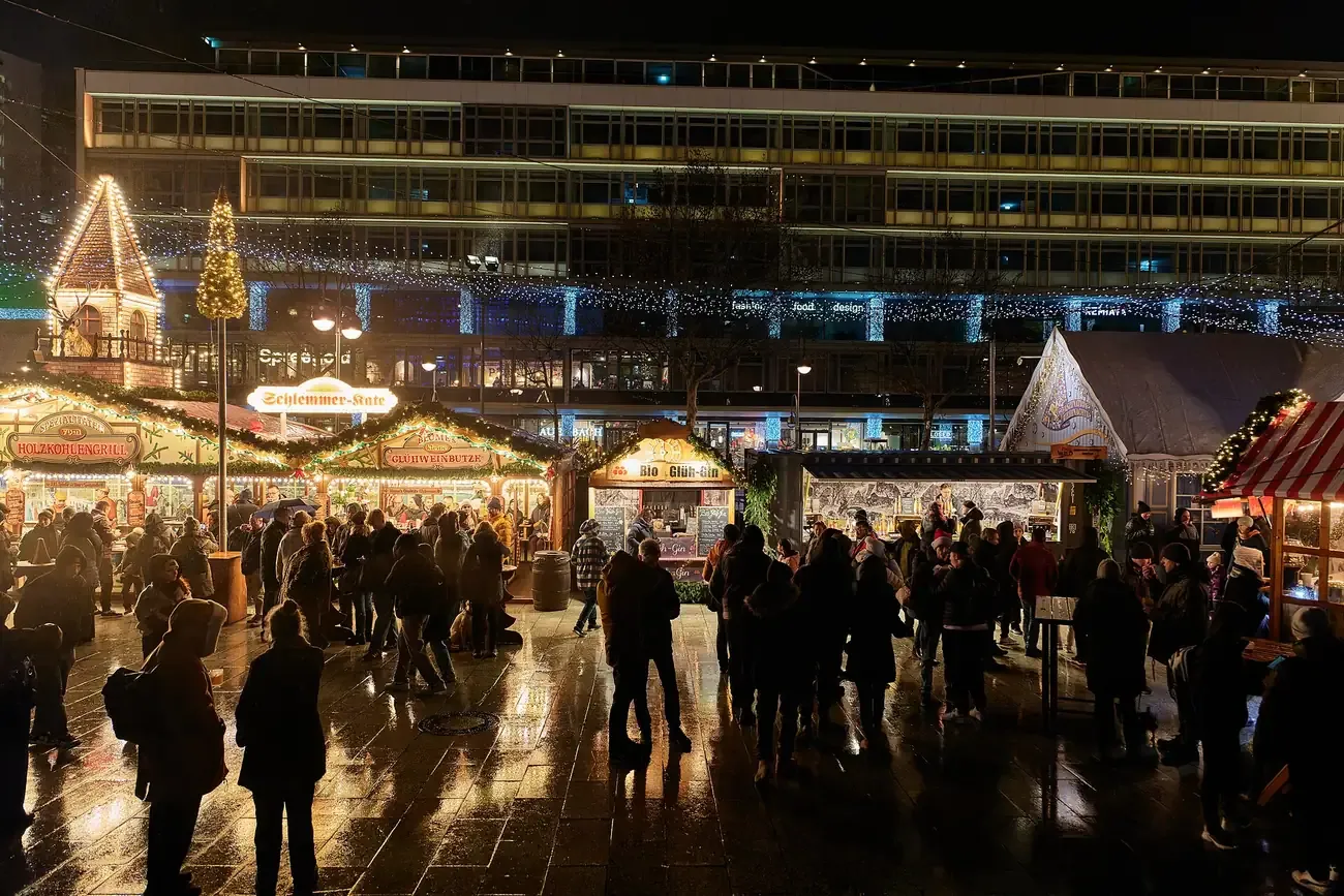 Stalls and visitors on Breitscheidplatz at the Christmas market by the Kaiser Wilhelm Memorial Church, Berlin