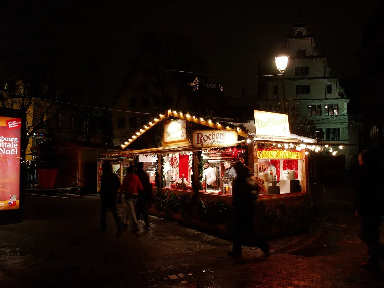 A lit Christmas market chalet on place du Château in Strasbourg at night