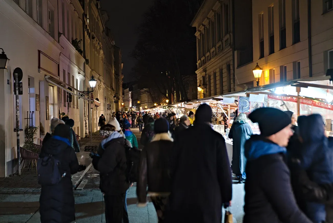 Stalls and visitors along Sophienstraße at the Christmas market near the Hackesche Höfe, Berlin