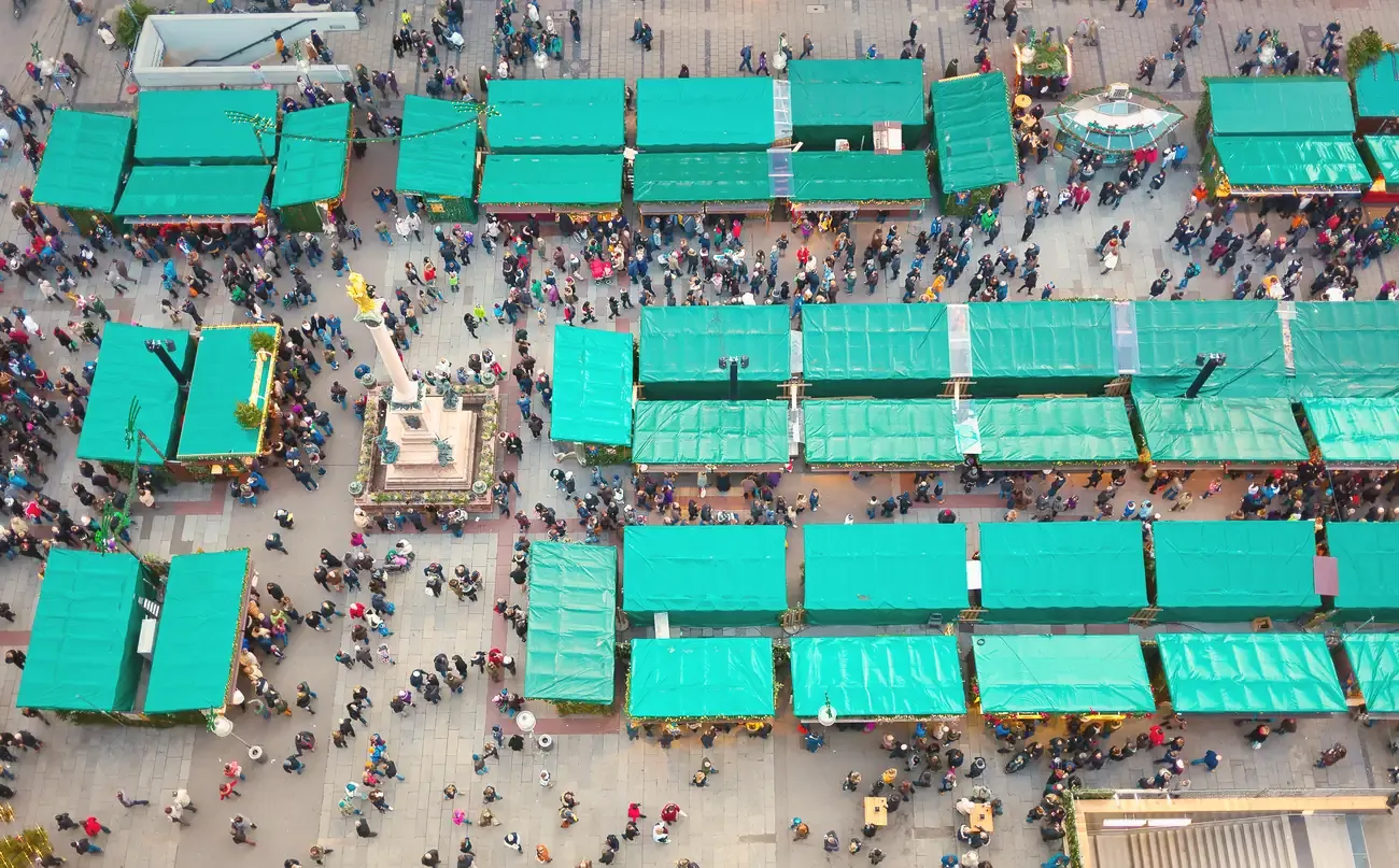 Aerial view of the green-roofed stalls of the Christmas market around Mary's Column on Marienplatz in Munich