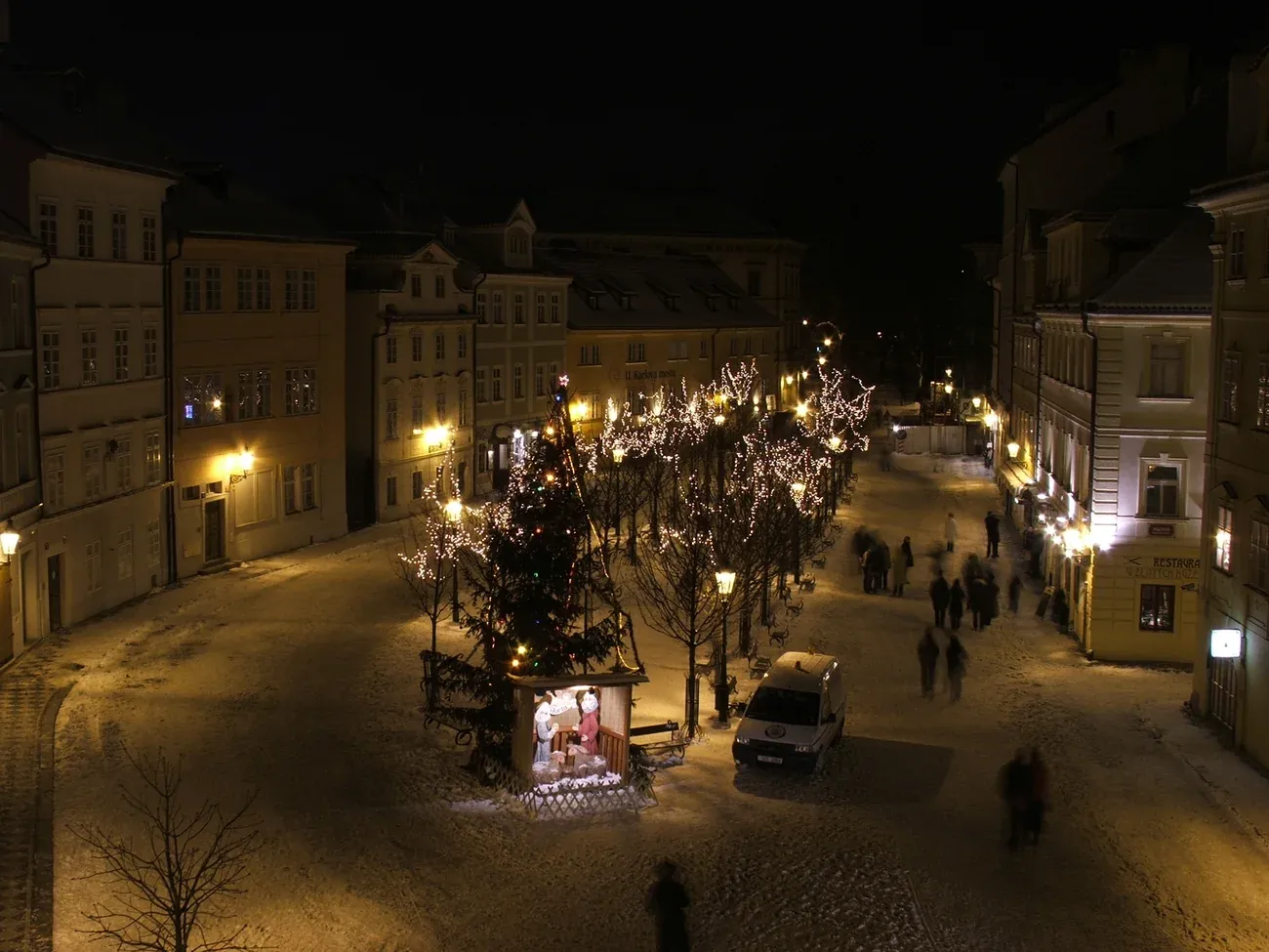 Christmas tree and a small stall on the square Na Kampě in the snow, Malá Strana, Prague