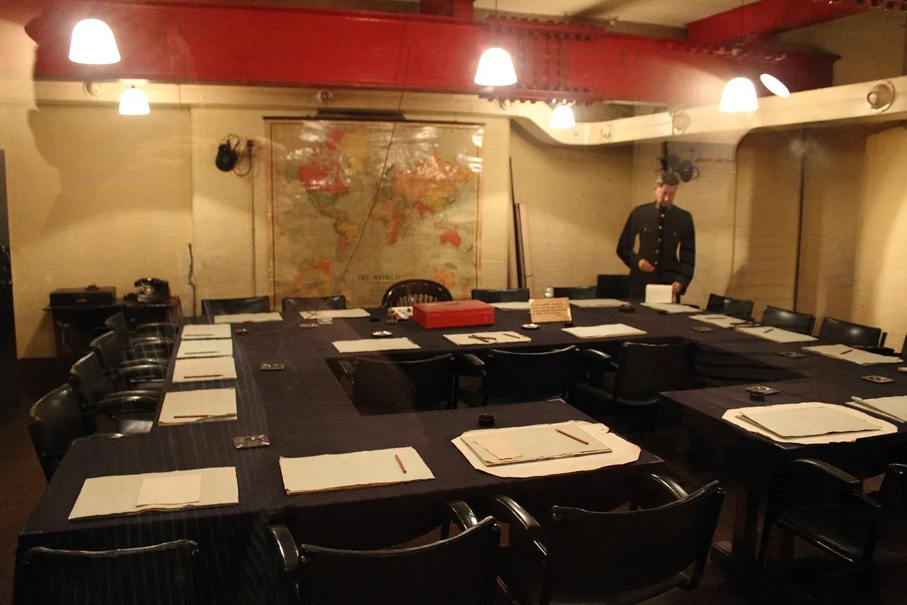 The Cabinet Room of the Churchill War Rooms in London, with the map of the world and the table laid for a meeting