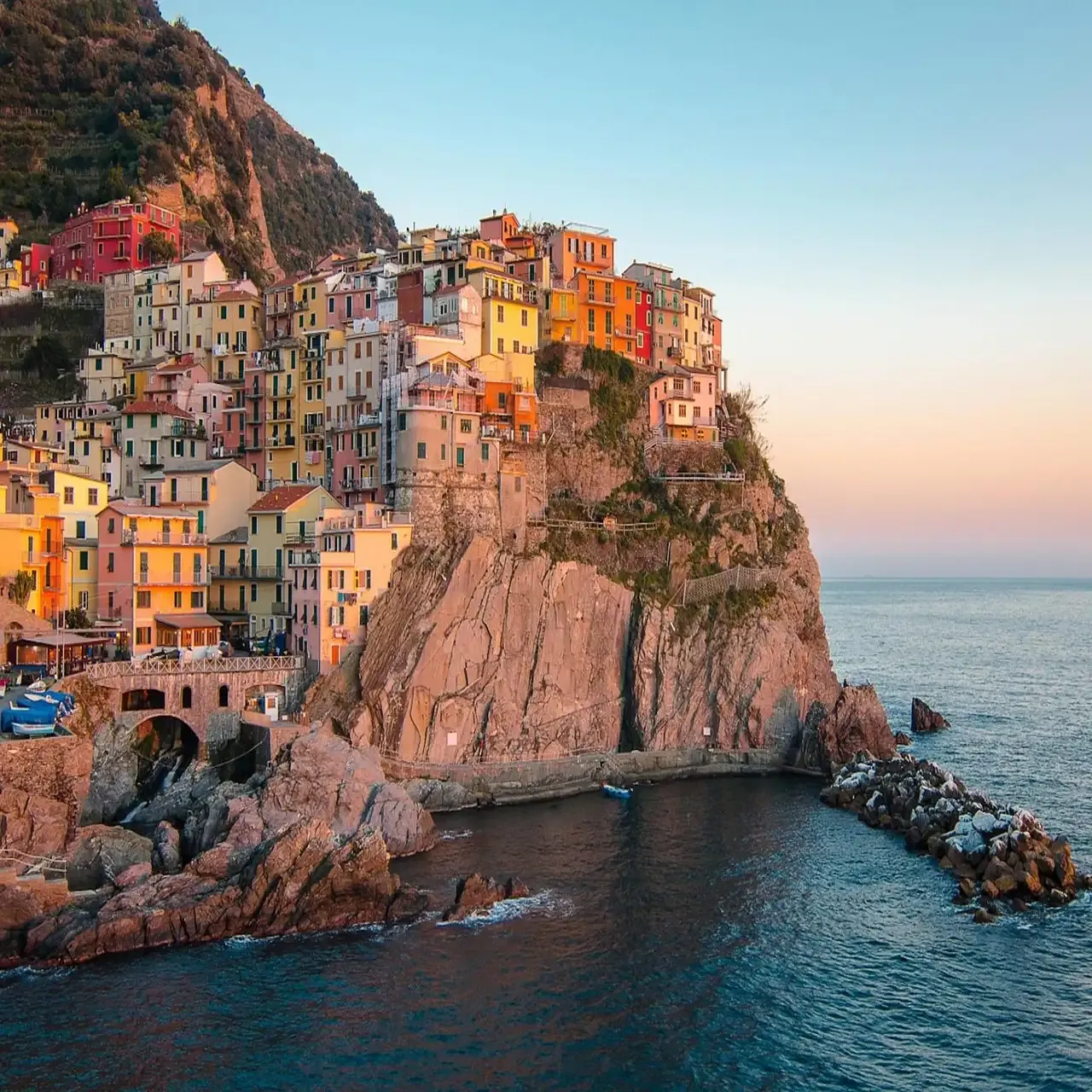 Manarola at sunset with painted houses on the cliff, Cinque Terre