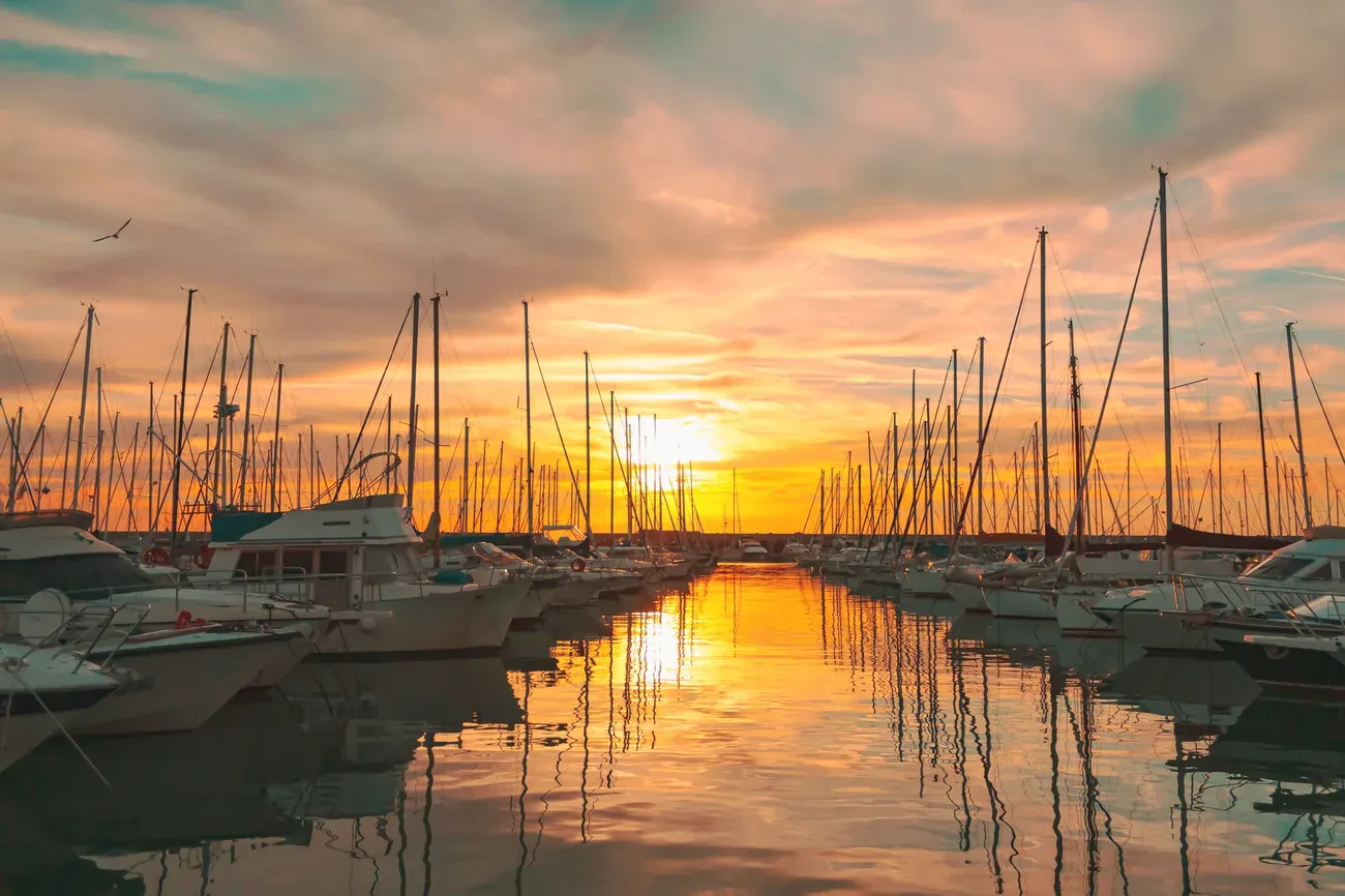 Sailboats moored in the marina at Civitavecchia, Italy, at sunset