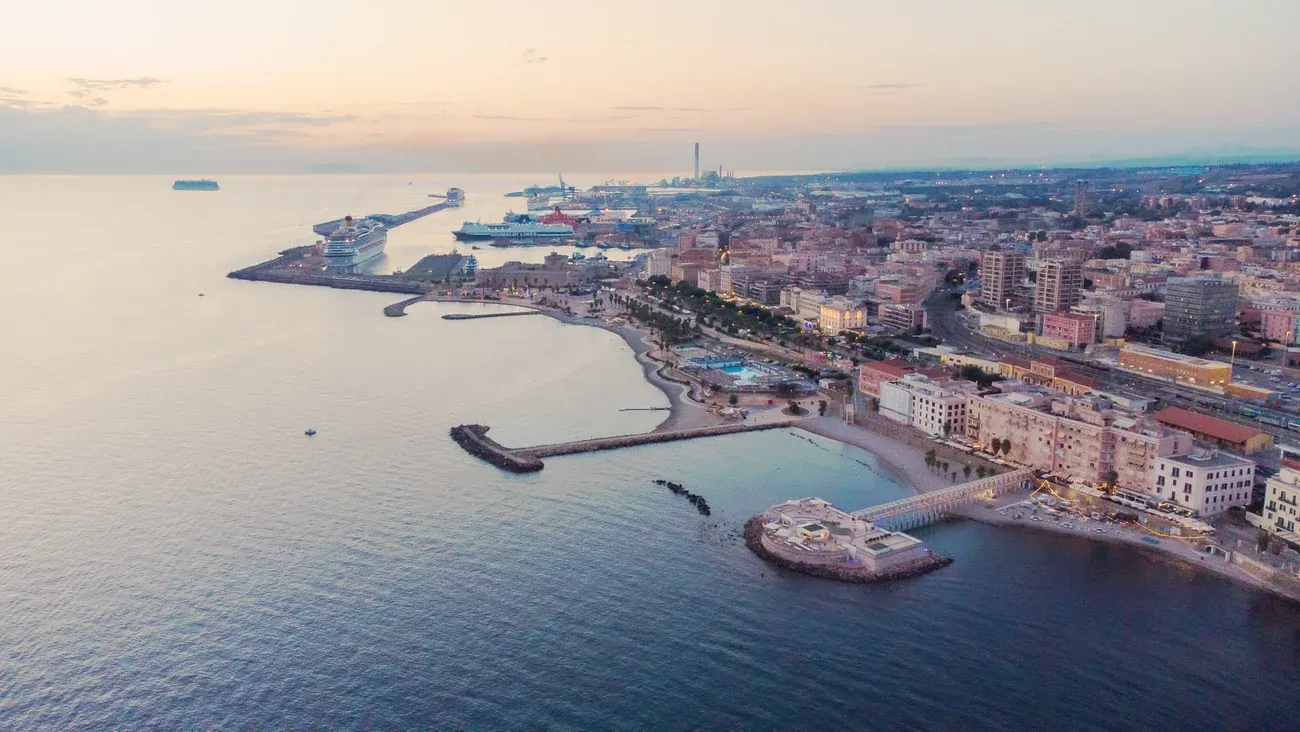 Aerial view of the Civitavecchia seafront, beach and cruise port at dusk, Italy