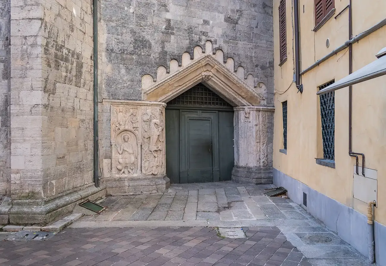 The carved Romanesque side portal of the Basilica di San Fedele in Como
