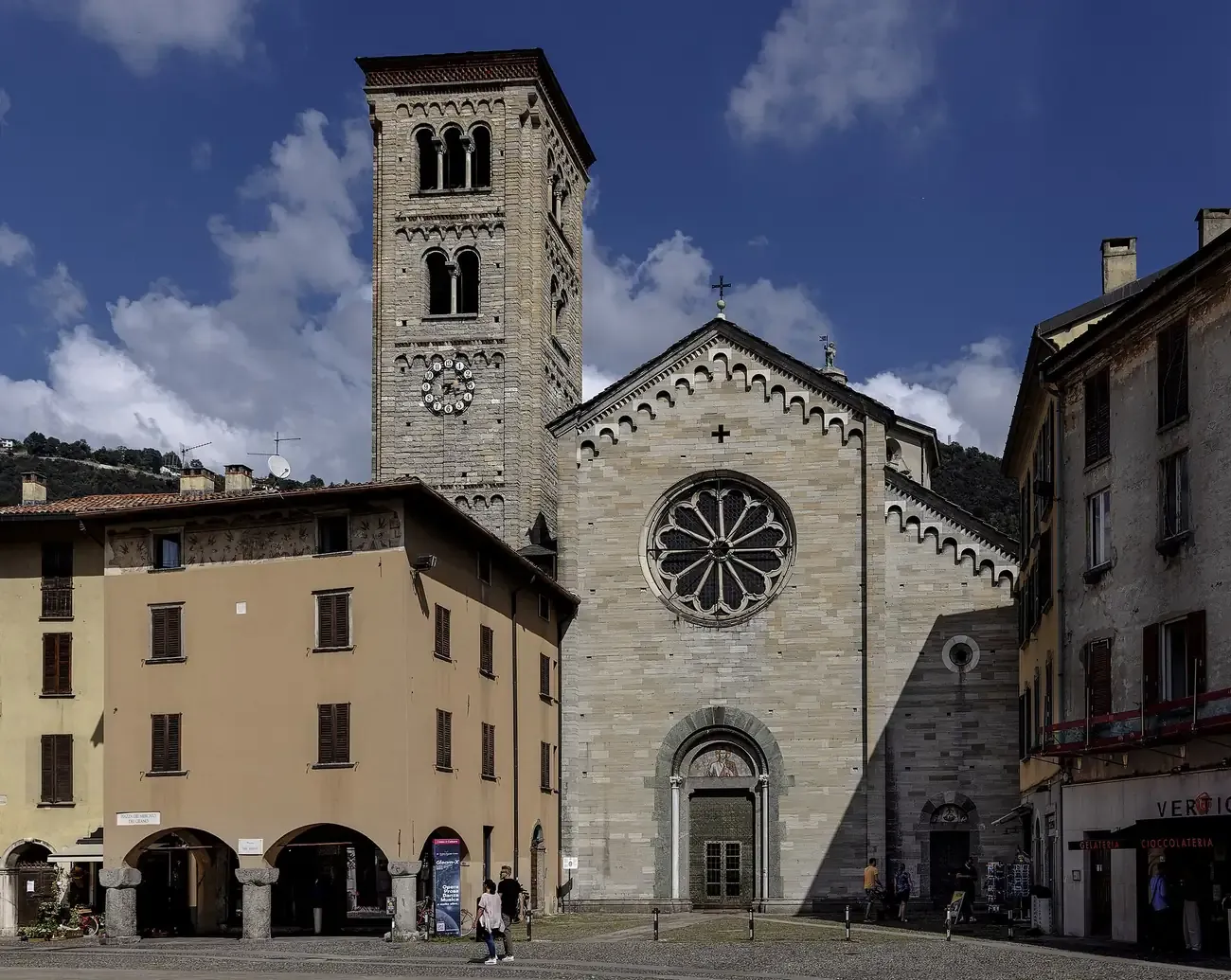 The stone facade, rose window and bell tower of the Basilica di San Fedele in Como
