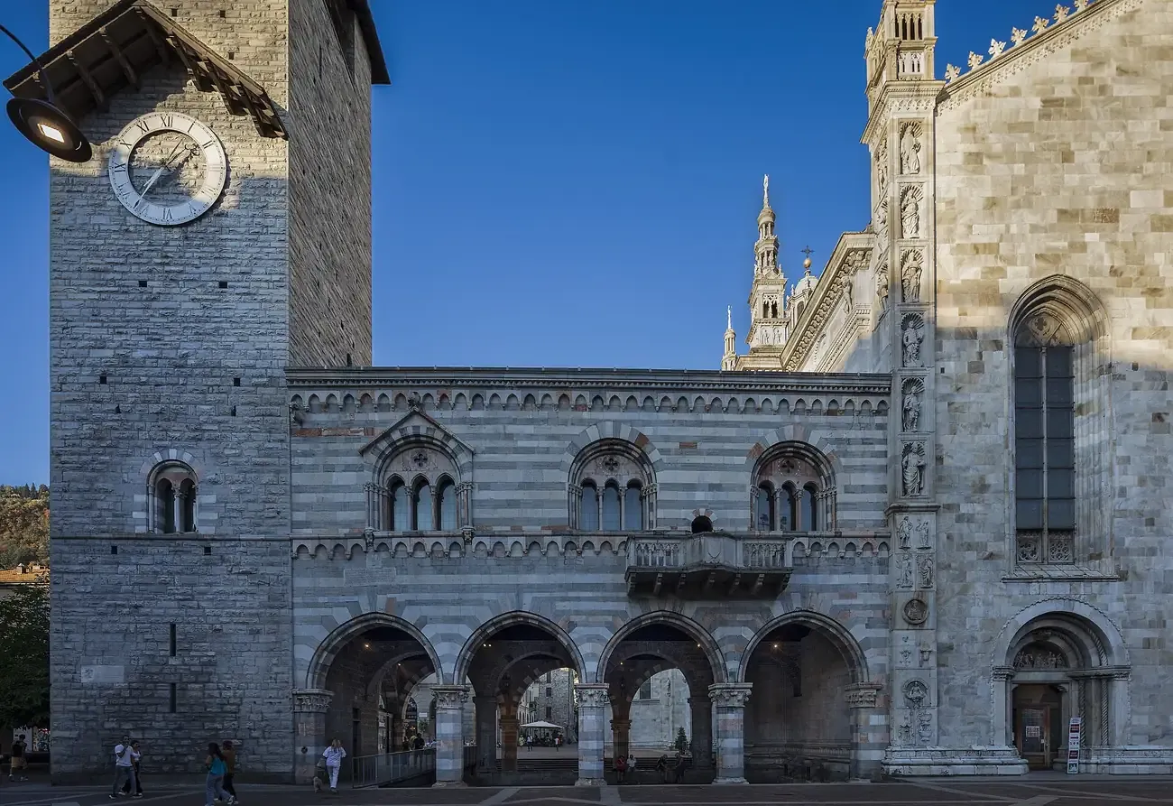 The striped marble Broletto of Como with its arcade and the Torre del Comune beside the cathedral