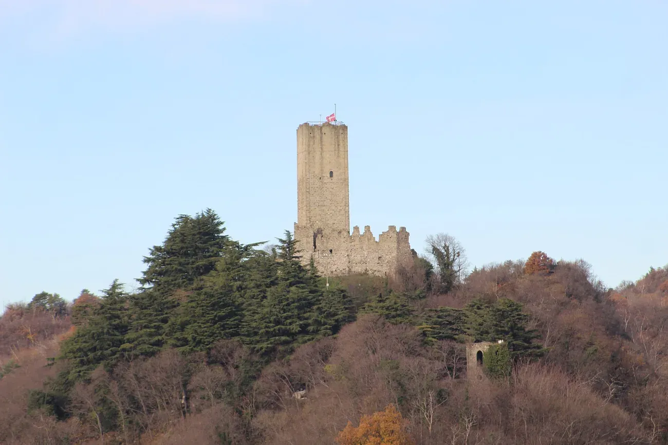 The medieval tower of Castello Baradello on its wooded hill above Como