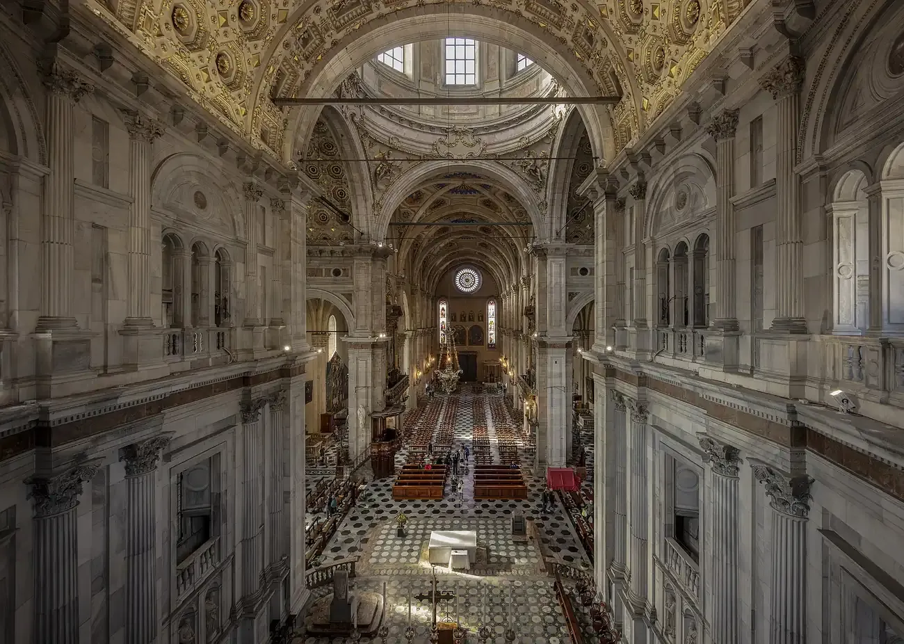 The long nave of Como Cathedral with its vaulted ceiling and marble floor