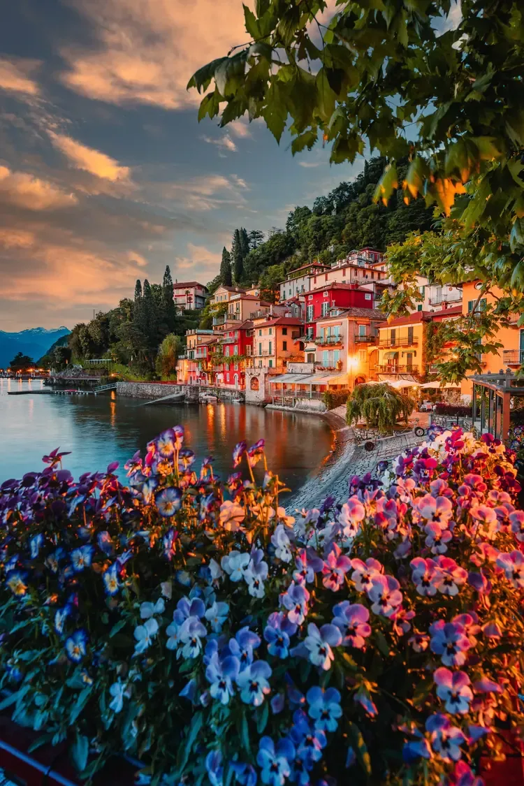 Varenna's illuminated houses on Lake Como at sunset, Italy
