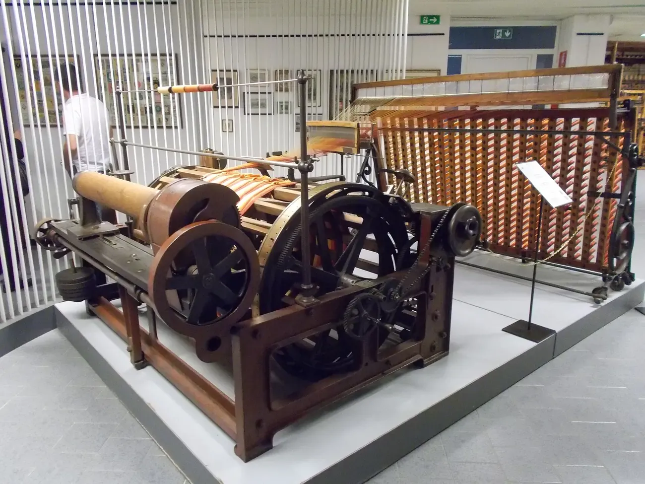 A historic sectional warping machine on display in the Museo della Seta in Como