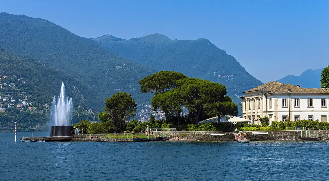 Villa Geno and its fountain jet on a point of the Lake Como shore near Como