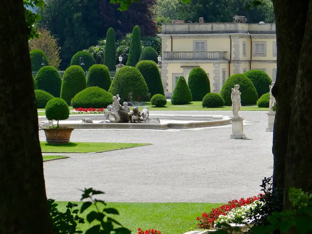 The fountain and clipped hedges of the Italian garden of Villa Olmo in Como