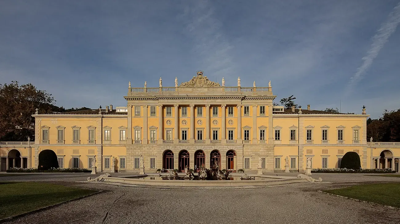 The neoclassical facade of Villa Olmo in Como seen across its forecourt