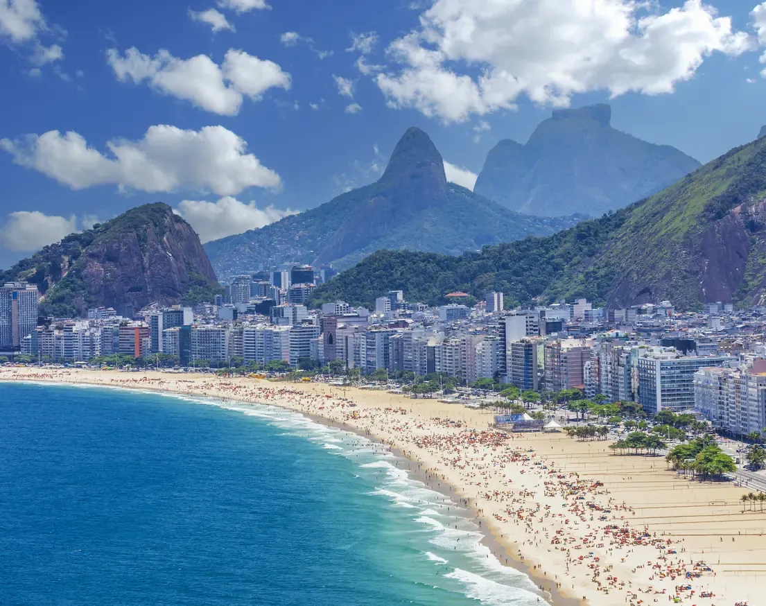 Aerial view of the long curve of Copacabana beach with the Dois Irmaos mountains beyond, Rio de Janeiro.