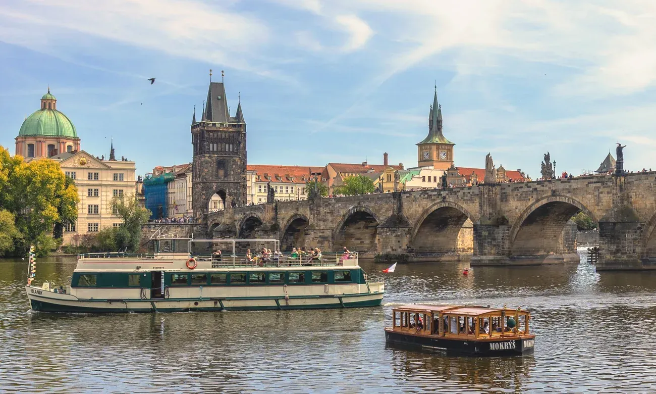 Cruise boats passing Charles Bridge on the Vltava