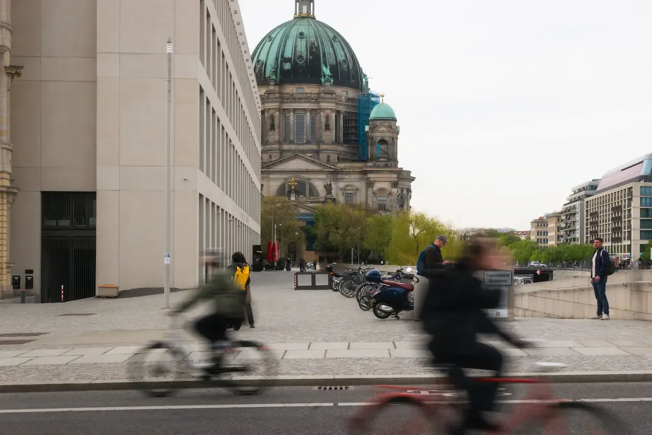 Cyclists passing by Berlin Cathedral