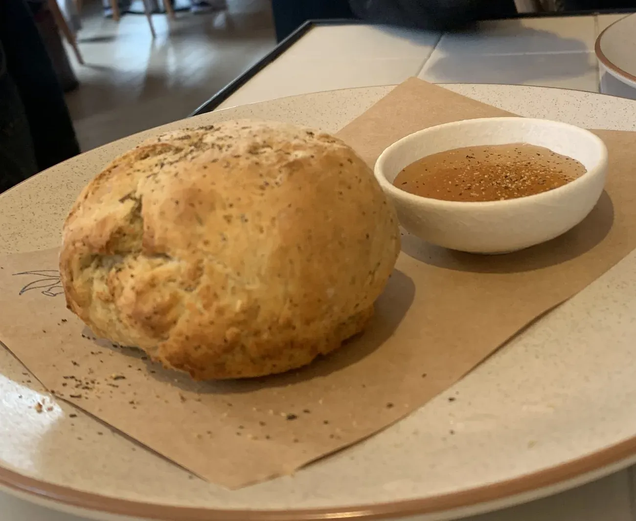 A round damper loaf served with a bowl of golden syrup