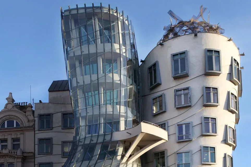 The curving glass facade of the Dancing House in Prague