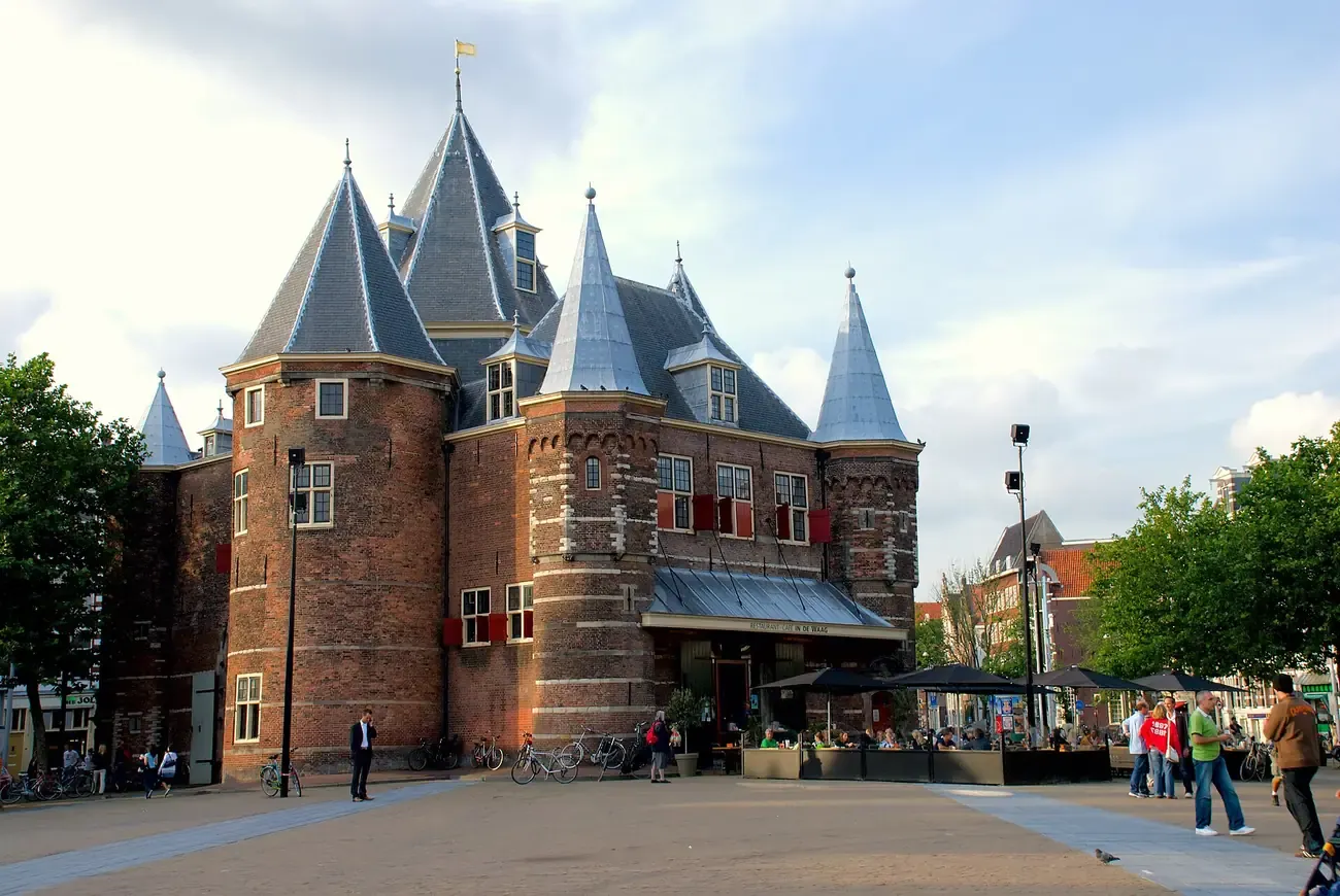 The turreted brick Waag weigh house standing on Nieuwmarkt square in Amsterdam