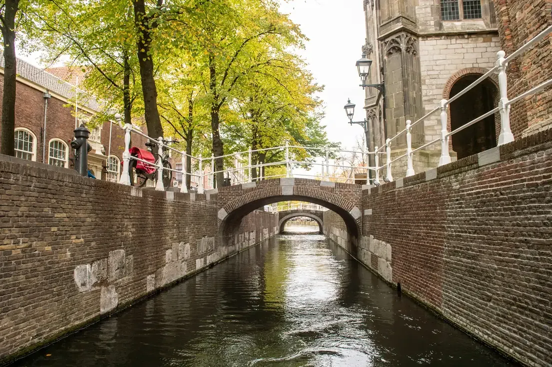 The narrowest canal in Delft, spanned by two old bridges, Netherlands