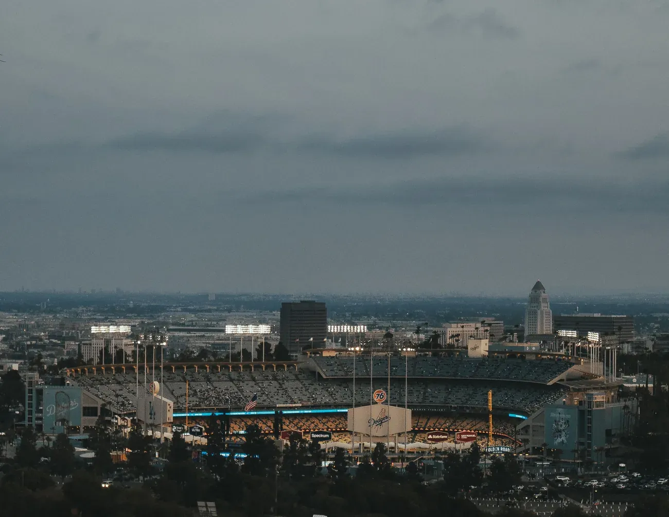 Dodger Stadium with the downtown Los Angeles skyline beyond at dusk