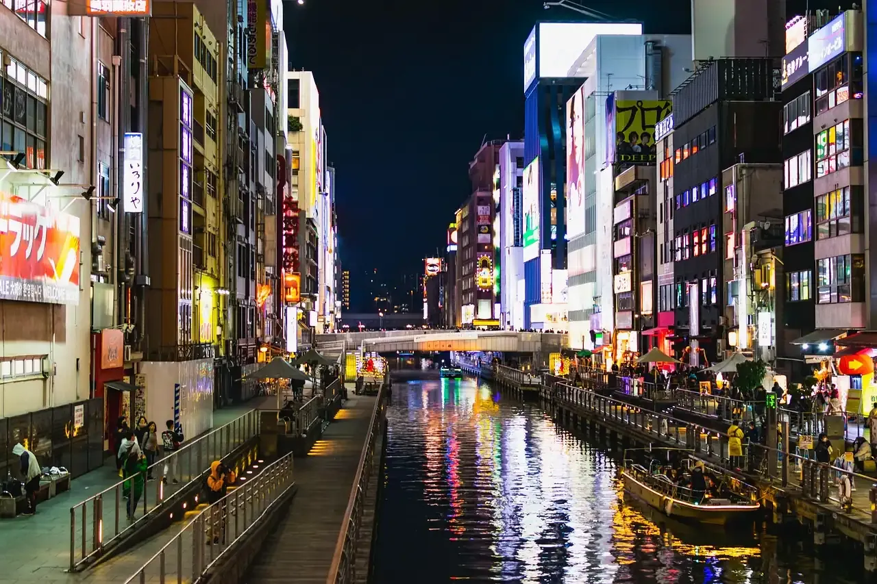 The Dotonbori canal lined with illuminated signs at night in Osaka