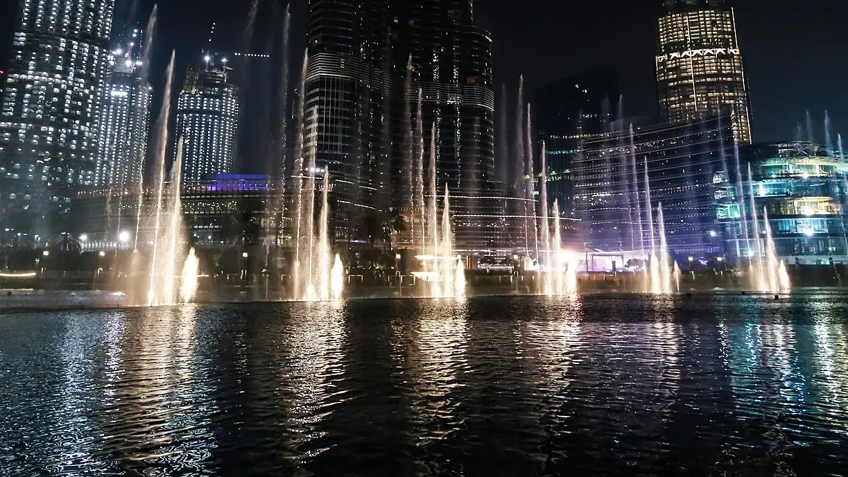 Jets of the Dubai Fountain lit during an evening show on Burj Lake
