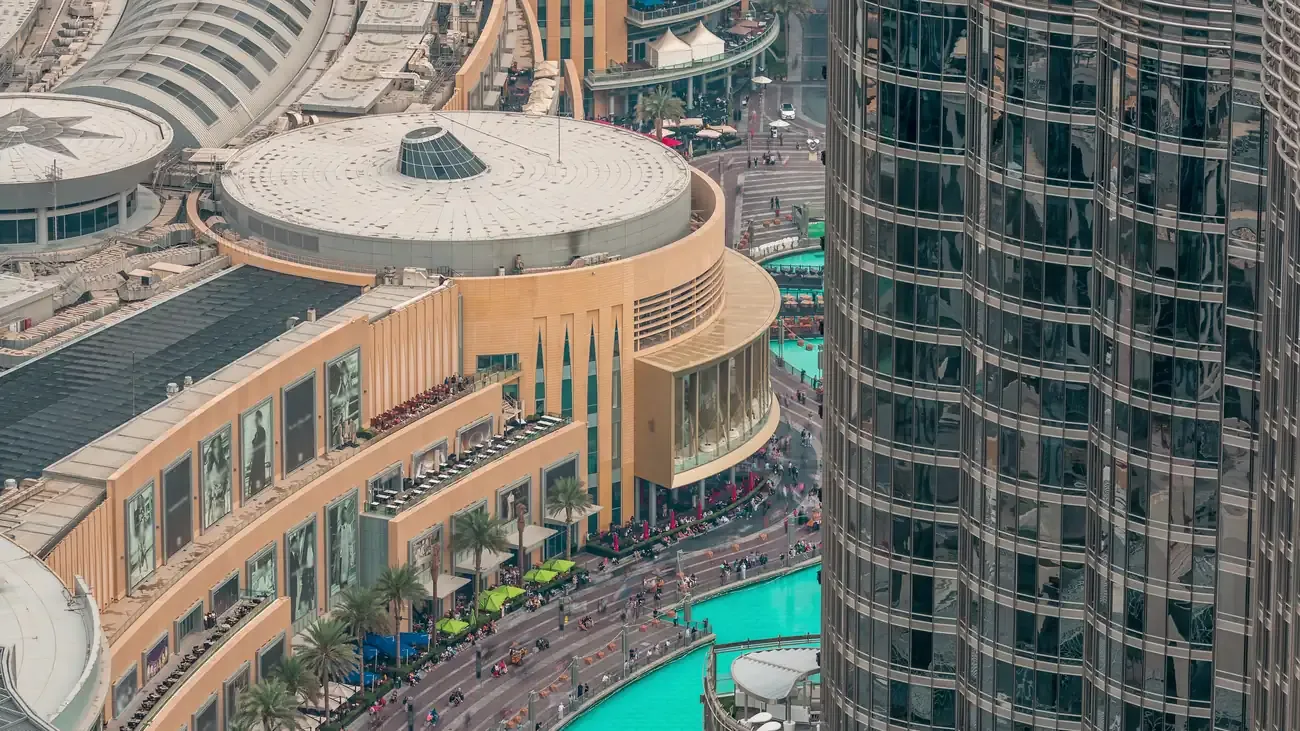 The Dubai Mall beside the Burj Khalifa and the fountain lake seen from above
