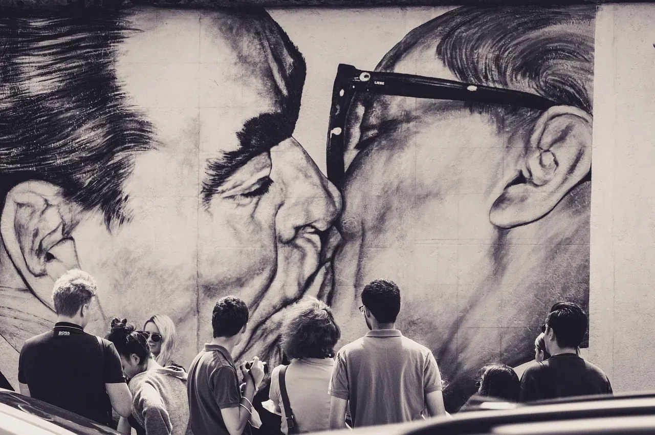 Visitors in front of the fraternal kiss mural at the East Side Gallery in Berlin