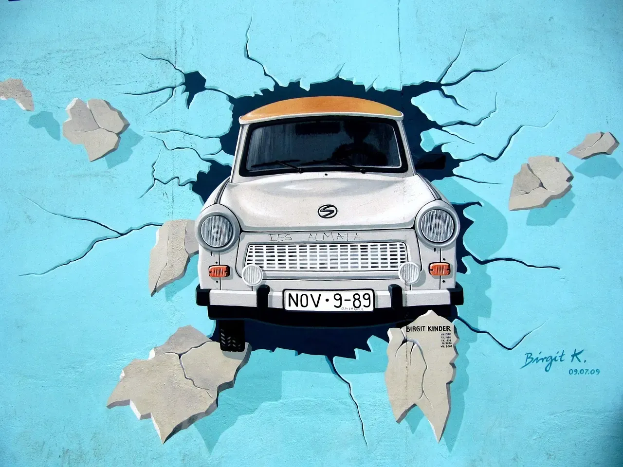 The Trabant mural breaking through the wall at the East Side Gallery in Berlin