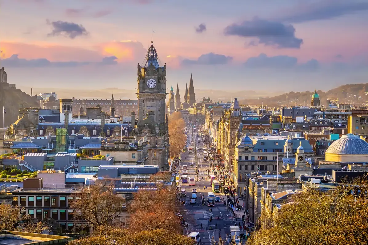 View along Princes Street towards the Balmoral clock tower from Calton Hill in Edinburgh at sunset